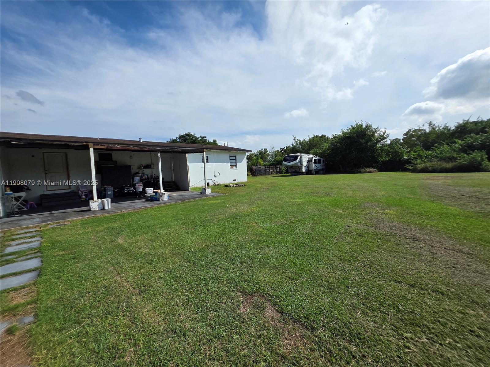 18200 Southwest 262nd Street Homestead, FL 33031 - Photo 25 of 30 a view of an house with backyard space and porch