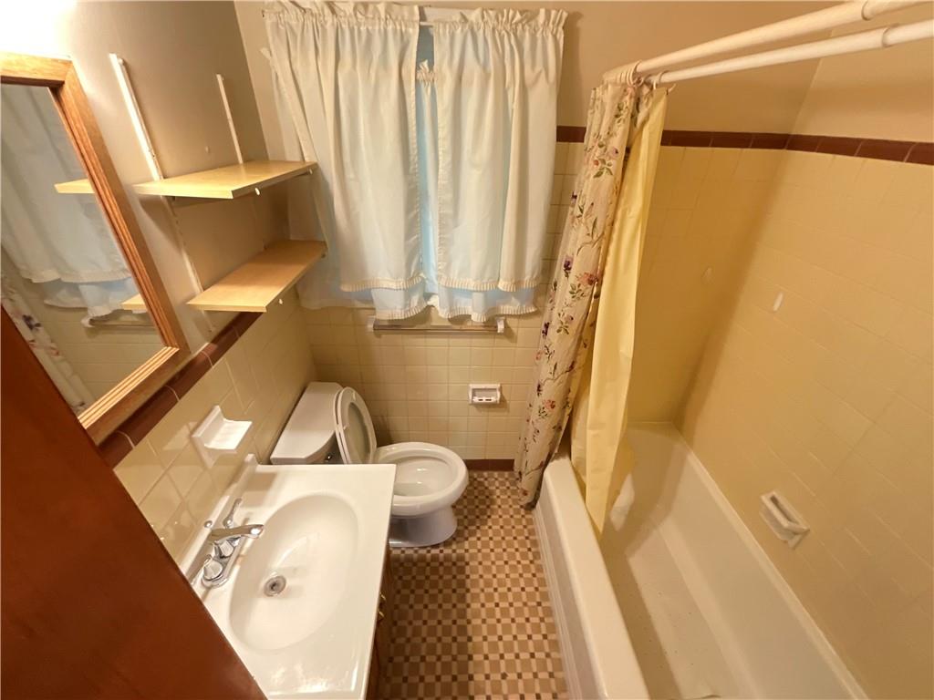 2492 Hunting Valley Drive Decatur, GA 30033 - Photo 22 of 30 a bathroom with a sink a toilet a mirror and a shower