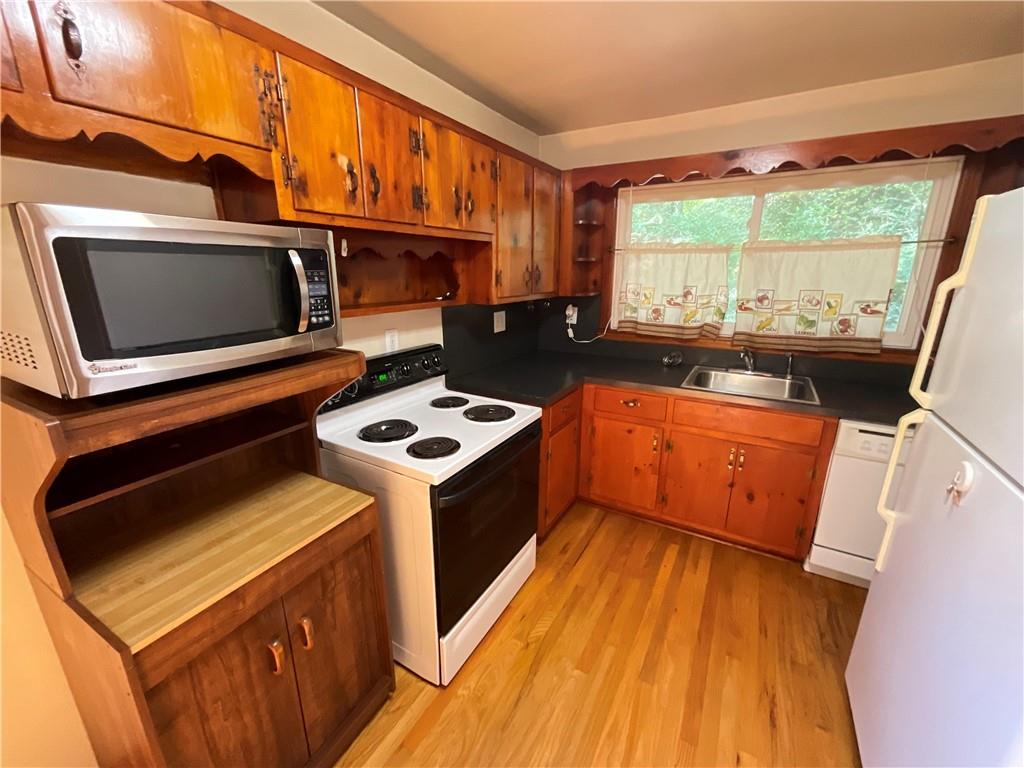 2492 Hunting Valley Drive Decatur, GA 30033 - Photo 26 of 30 a kitchen with a stove a sink and a microwave