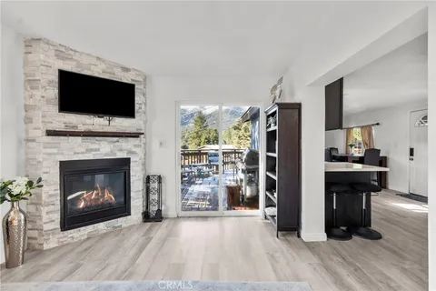 a living room with furniture fireplace and flat screen tv