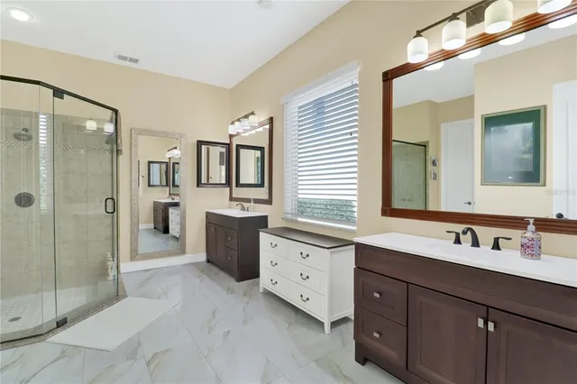 a bathroom with a double vanity sink mirror and double