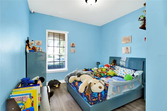 a bathroom with a granite countertop toilet a sink and a mirror
