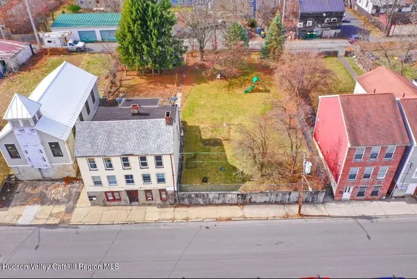 an aerial view of residential houses with outdoor space