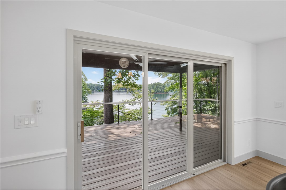 304 Lakeside Drive Seneca, SC 29672 - Photo 21 of 50 Sliding glass doors open onto the spacious deck, offering commanding lake views.