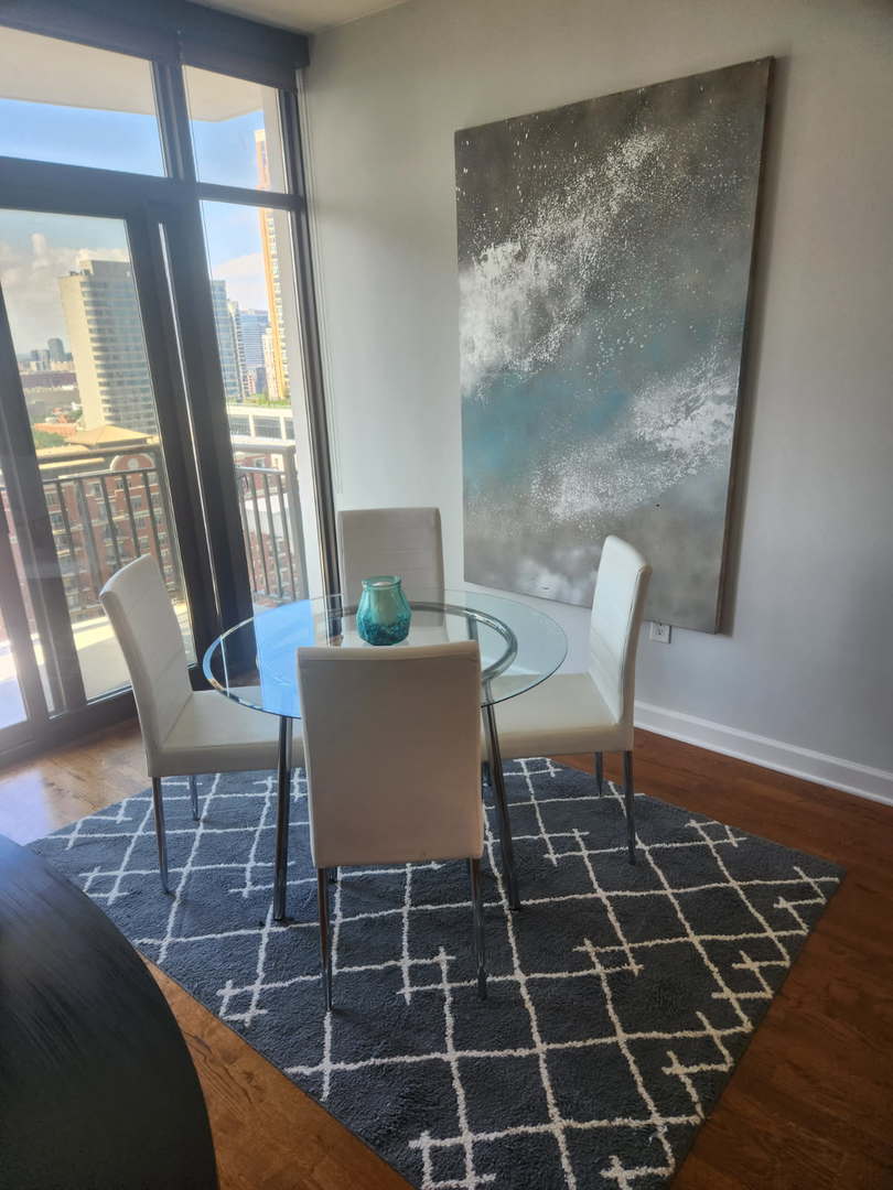 233 East 13th Street, Unit 2210 Chicago, IL 60605 - Photo 11 of 28 a view of a dining room with furniture wooden floor and a potted plant
