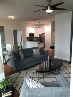 a living room with furniture and a chandelier