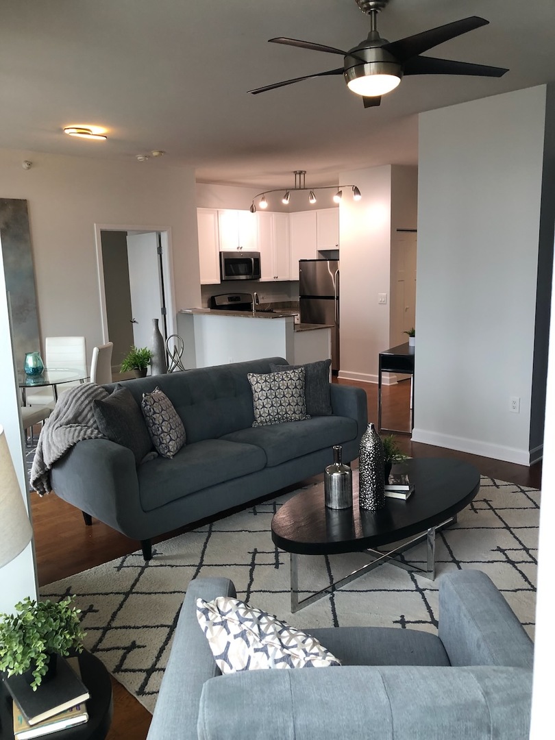 233 East 13th Street, Unit 2210 Chicago, IL 60605 - Photo 5 of 28 a living room with furniture and a chandelier