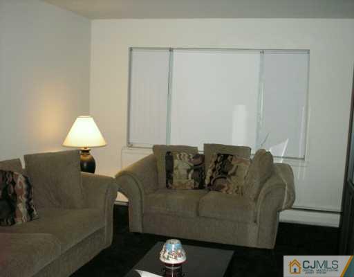 50 Fox Road, Unit 8A Edison, NJ 08817 - Photo 3 of 8 a living room with furniture and a lamp