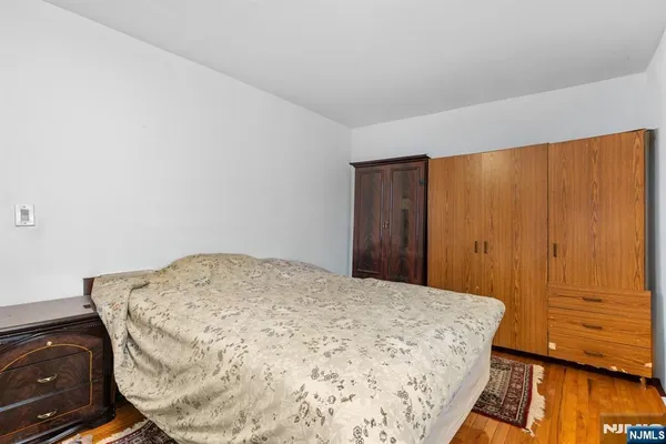 a bed sitting in a bedroom next to a cabinet
