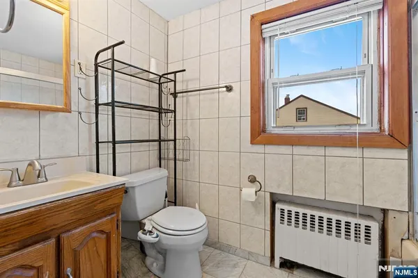 a bathroom with a toilet a sink and shower