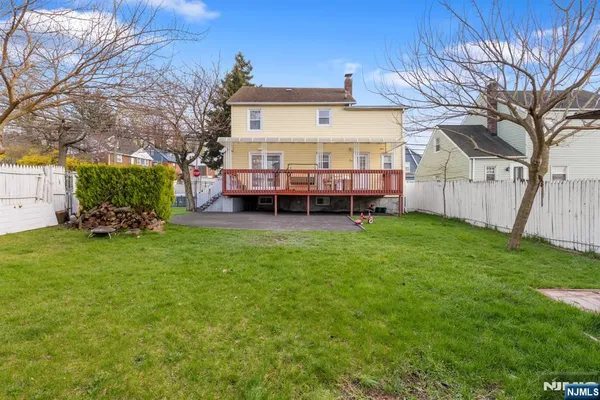 a view of a house with a yard and sitting area