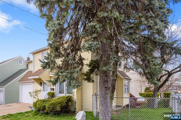 front view of a house with a tree