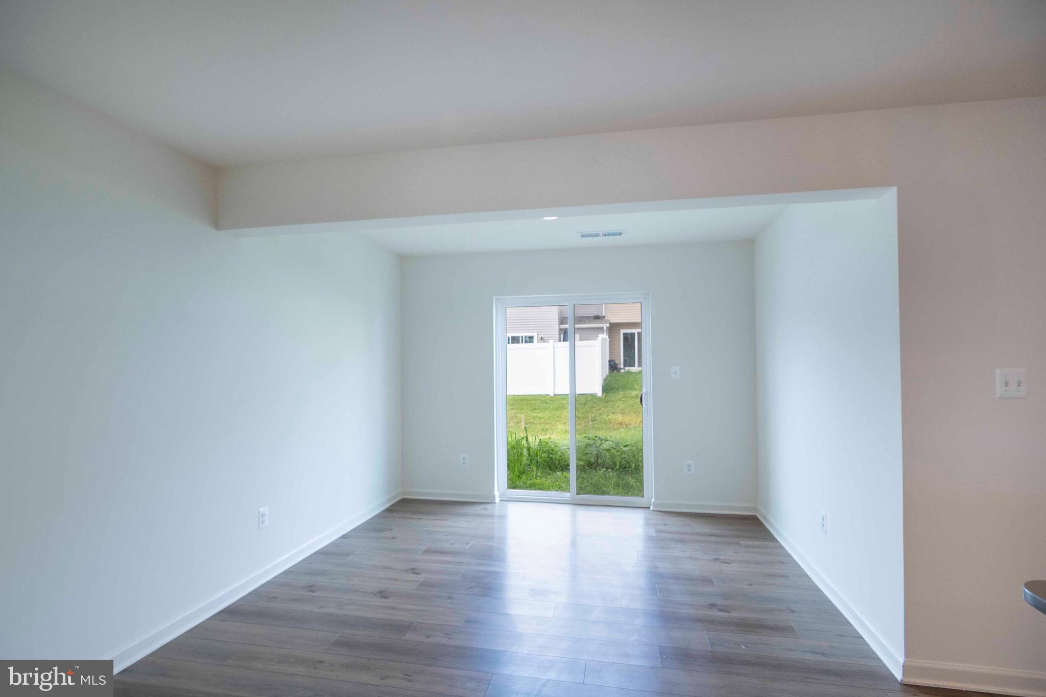 15 Pitch Pine Bunker Hill, WV 25413 - Photo 11 of 37 a view of an empty room with wooden floor and a window