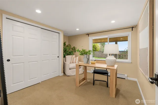a work room with furniture and a large window