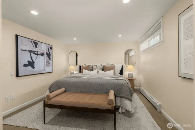 a bedroom with a bed and paintings on the wall