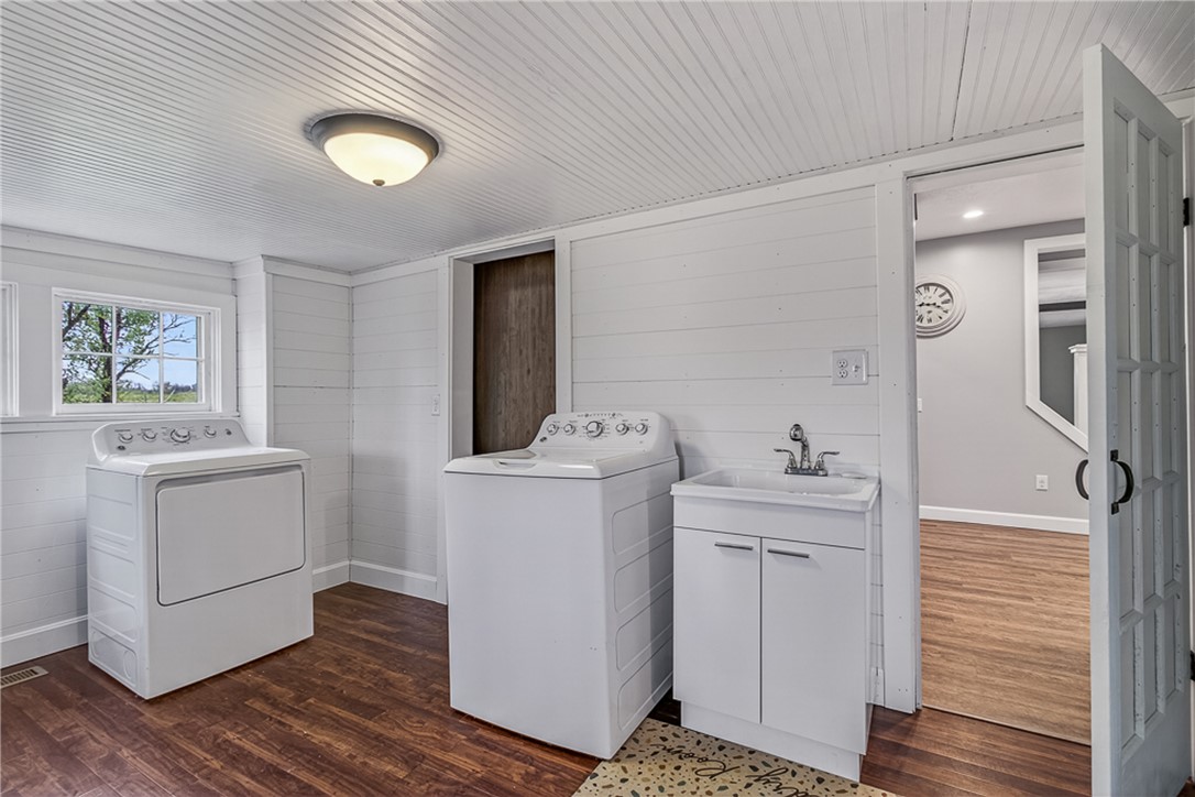 8700 Quaker Trace Road Camden, OH 45311 - Photo 10 of 34 Functional laundry room featuring a utility sink and durable wood flooring.