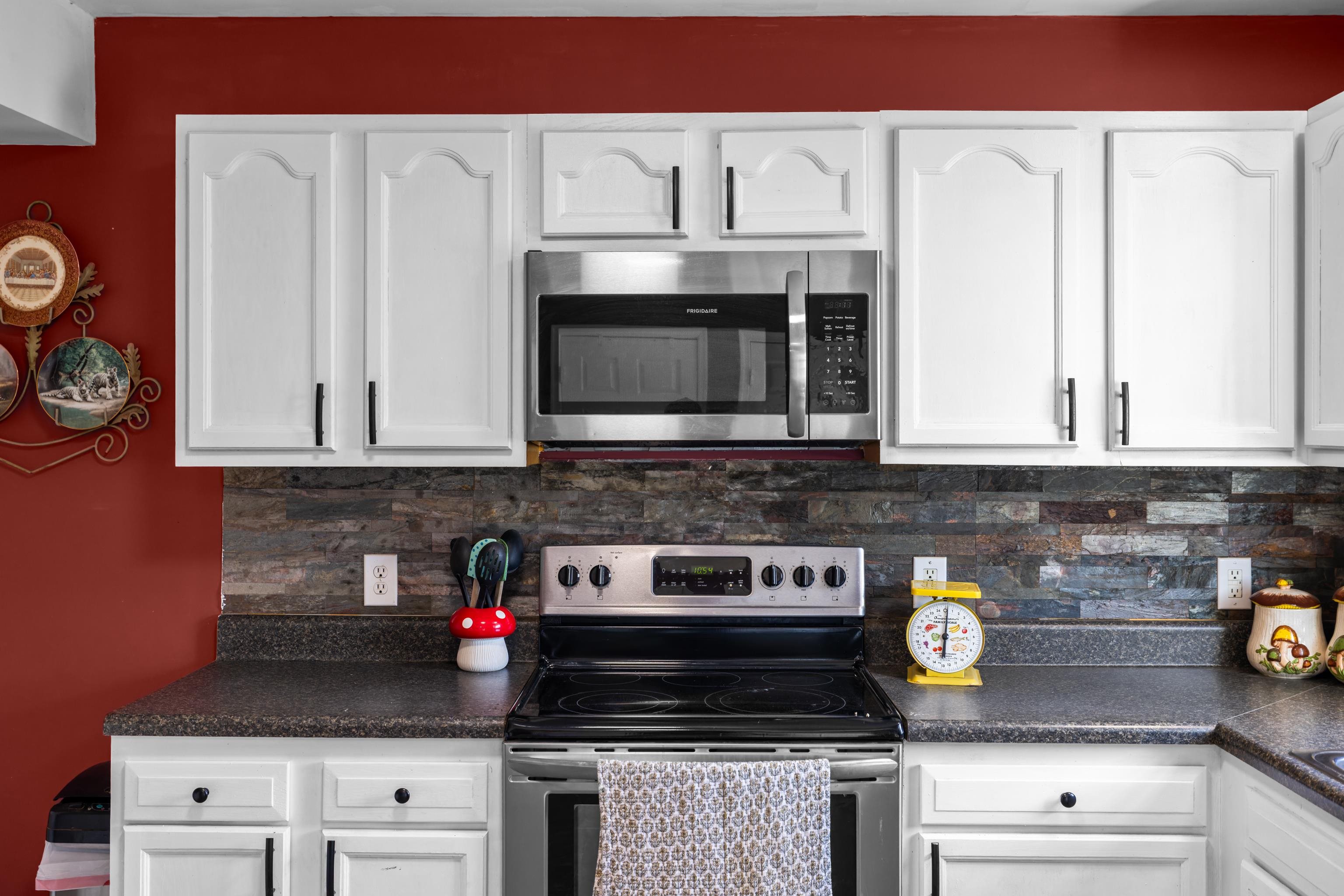 1520 3rd Street Waynesboro, VA 22980 - Photo 14 of 55 a kitchen with stainless steel appliances granite countertop stove top oven and cabinets