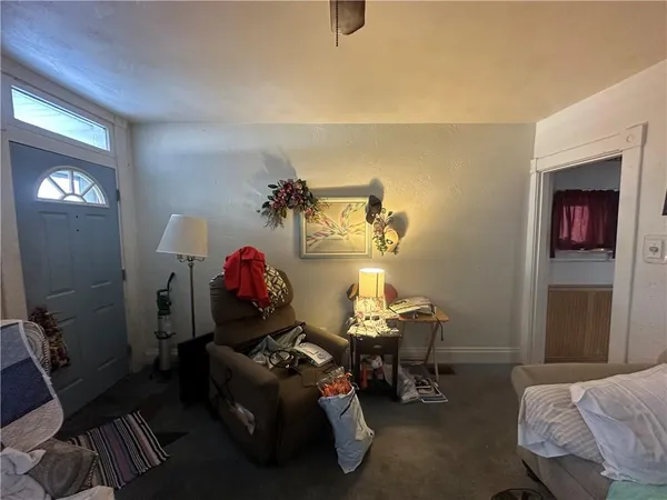 a living room with furniture and a chandelier