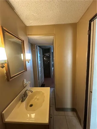 a en suite bathroom with a sink and mirror