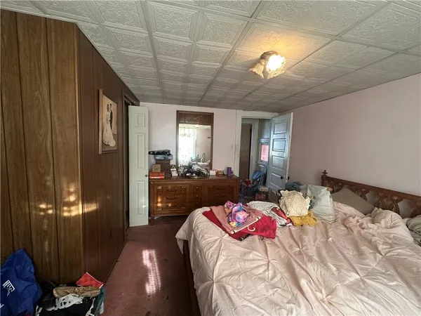 a bedroom with a bed and a couch