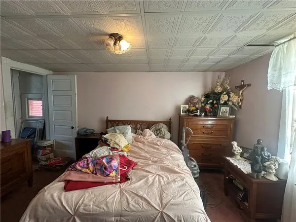 a bedroom with a bed and a chandelier
