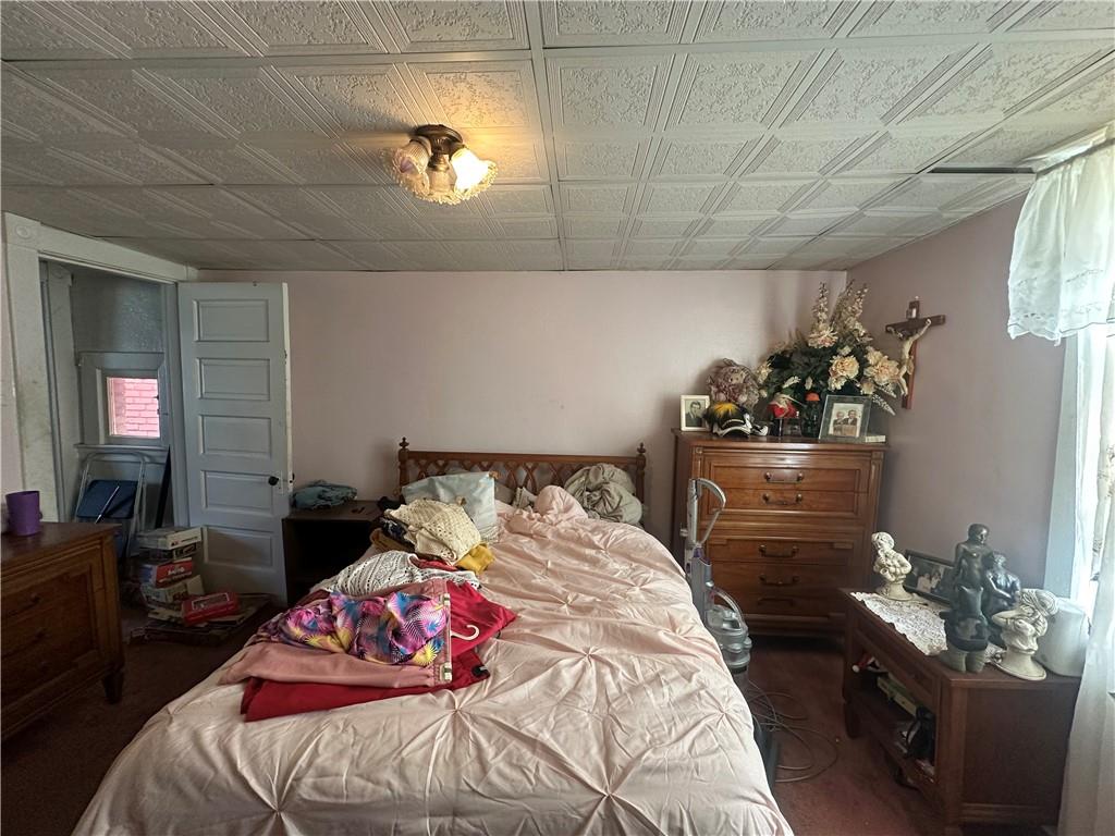 83 Frazier Avenue McKees Rocks, PA 15136 - Photo 21 of 27 a bedroom with a bed and a couch