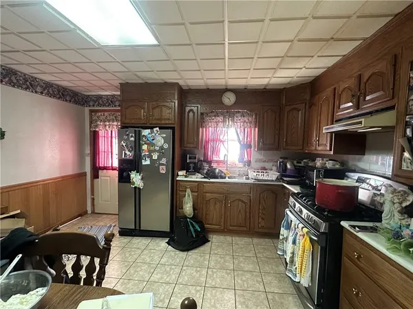 a kitchen with stainless steel appliances granite countertop a stove a sink dishwasher and a refrigerator