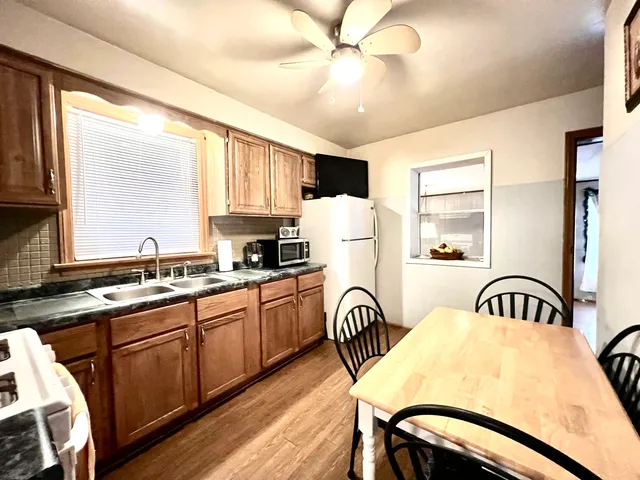 a bedroom with a bed a table and chair