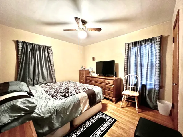 a bedroom with a bed and a television