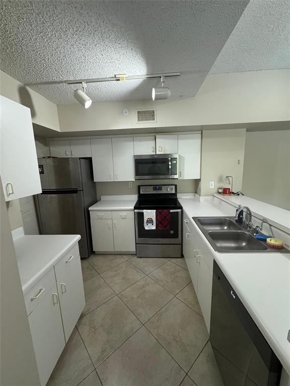 2600 South University Drive, Unit 309 Davie, FL 33328 - Photo 9 of 23 a kitchen with a sink a stove and refrigerator