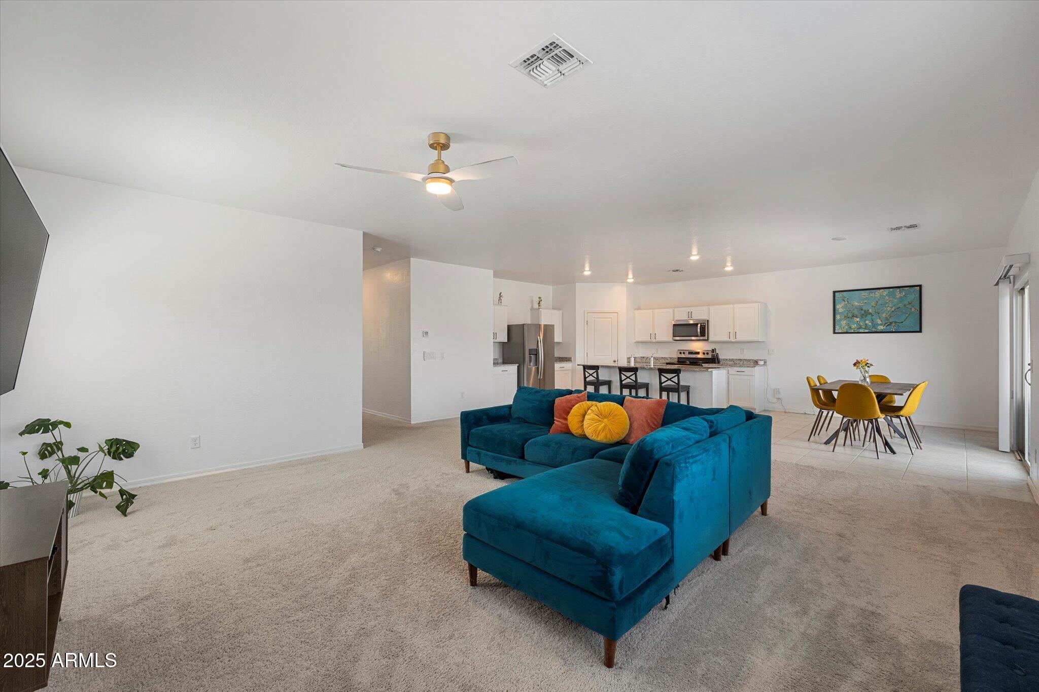 6350 West Latona Road Laveen, AZ 85339 - Photo 12 of 42 a living room with furniture kitchen view and a chandelier