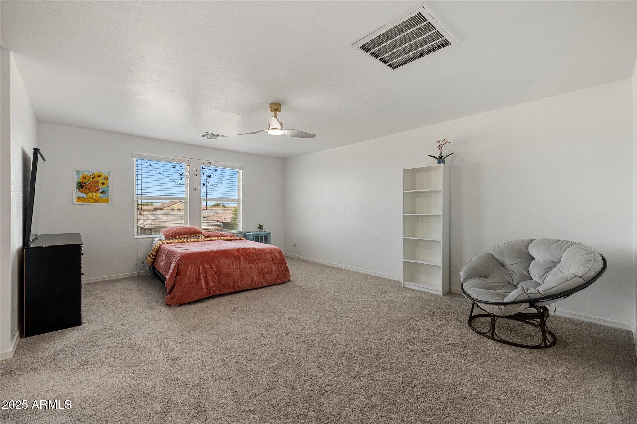 6350 West Latona Road Laveen, AZ 85339 - Photo 17 of 42 a bedroom with a bed and cabinets