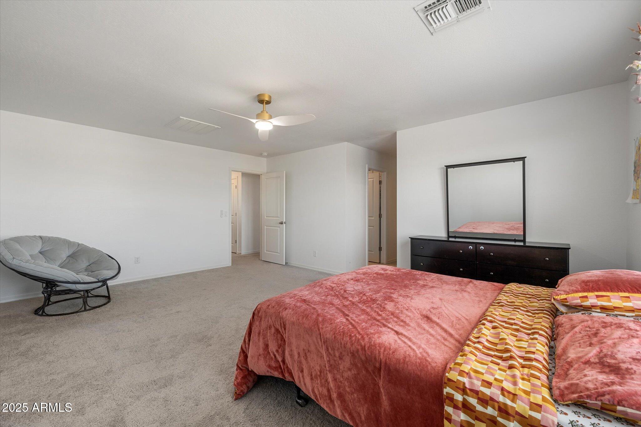 6350 West Latona Road Laveen, AZ 85339 - Photo 18 of 42 a bedroom with a bed and a chair