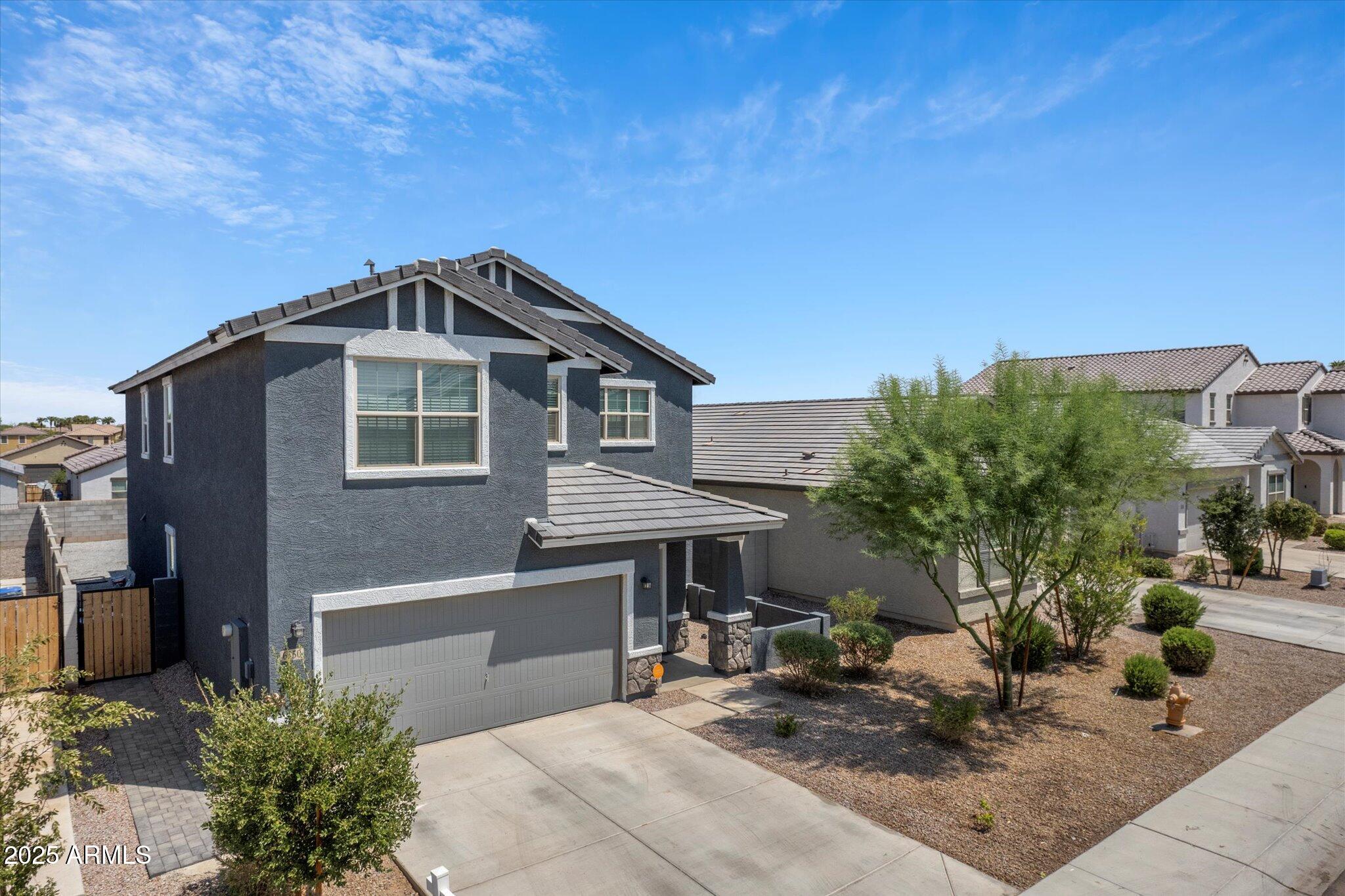 6350 West Latona Road Laveen, AZ 85339 - Photo 2 of 42 a front view of a house with garden