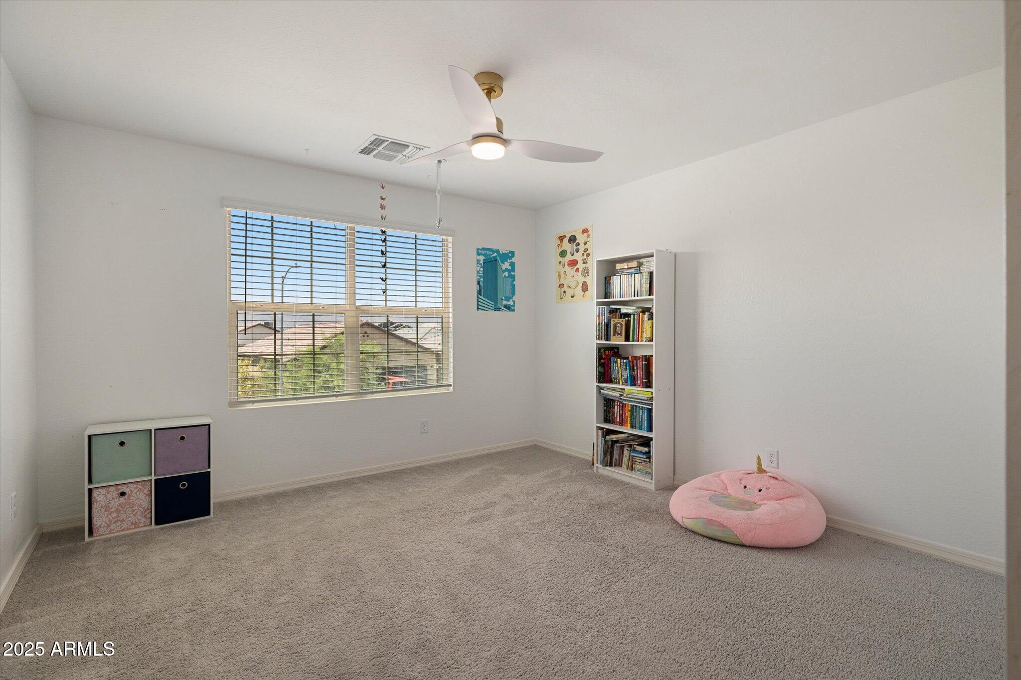 6350 West Latona Road Laveen, AZ 85339 - Photo 32 of 42 an empty room with windows and cabinet