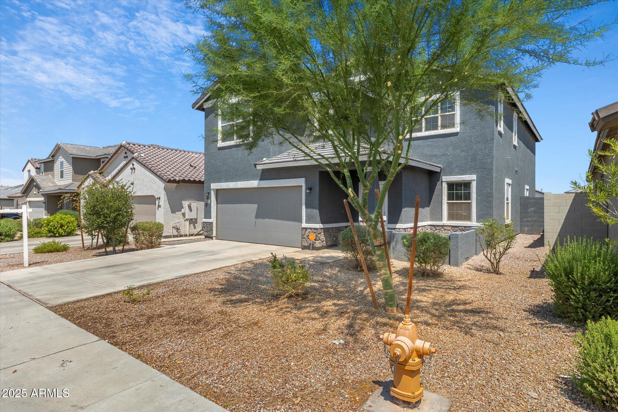 6350 West Latona Road Laveen, AZ 85339 - Photo 5 of 42 a front view of a house with a tree