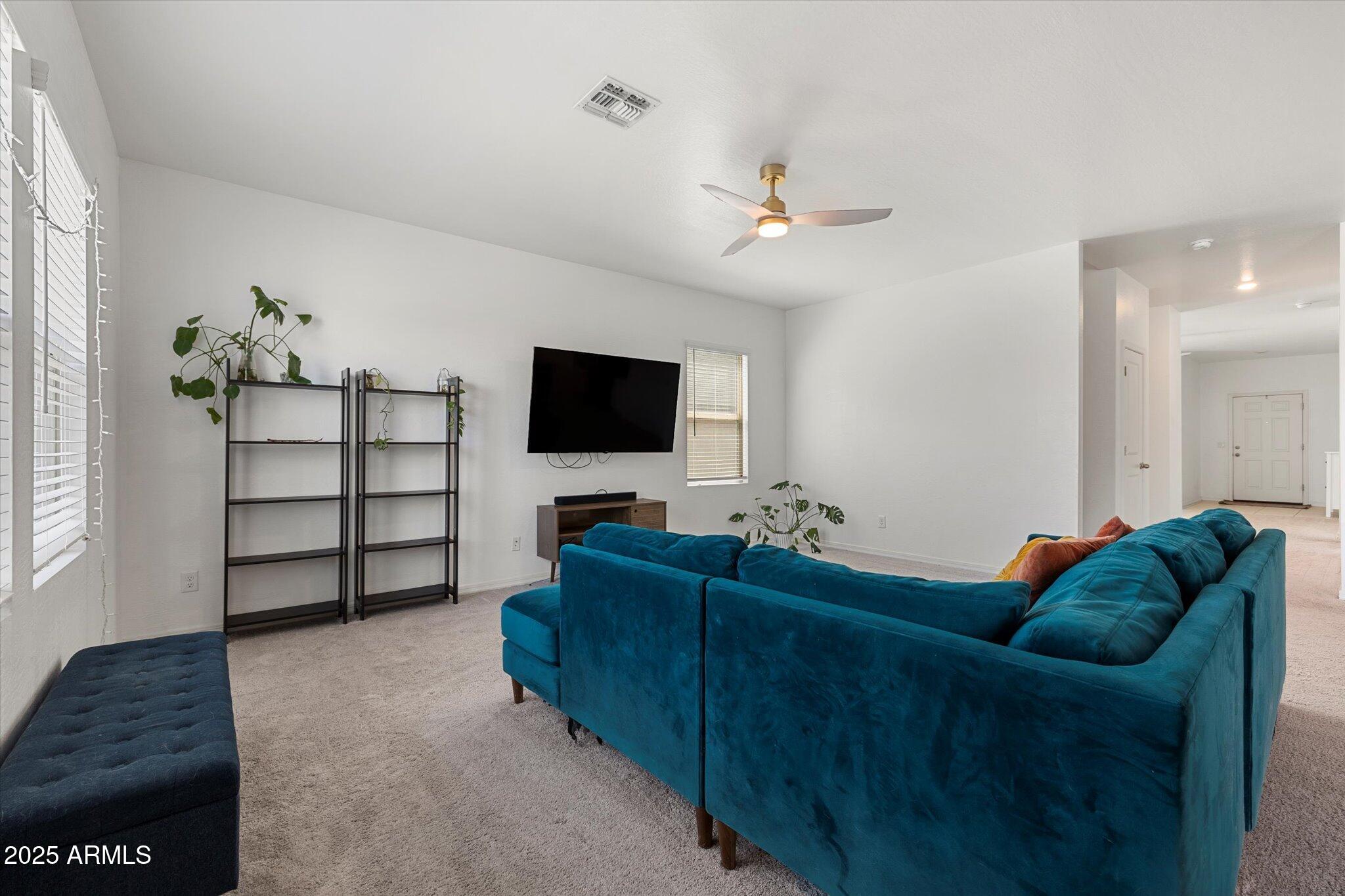 6350 West Latona Road Laveen, AZ 85339 - Photo 9 of 42 a living room with furniture and a flat screen tv