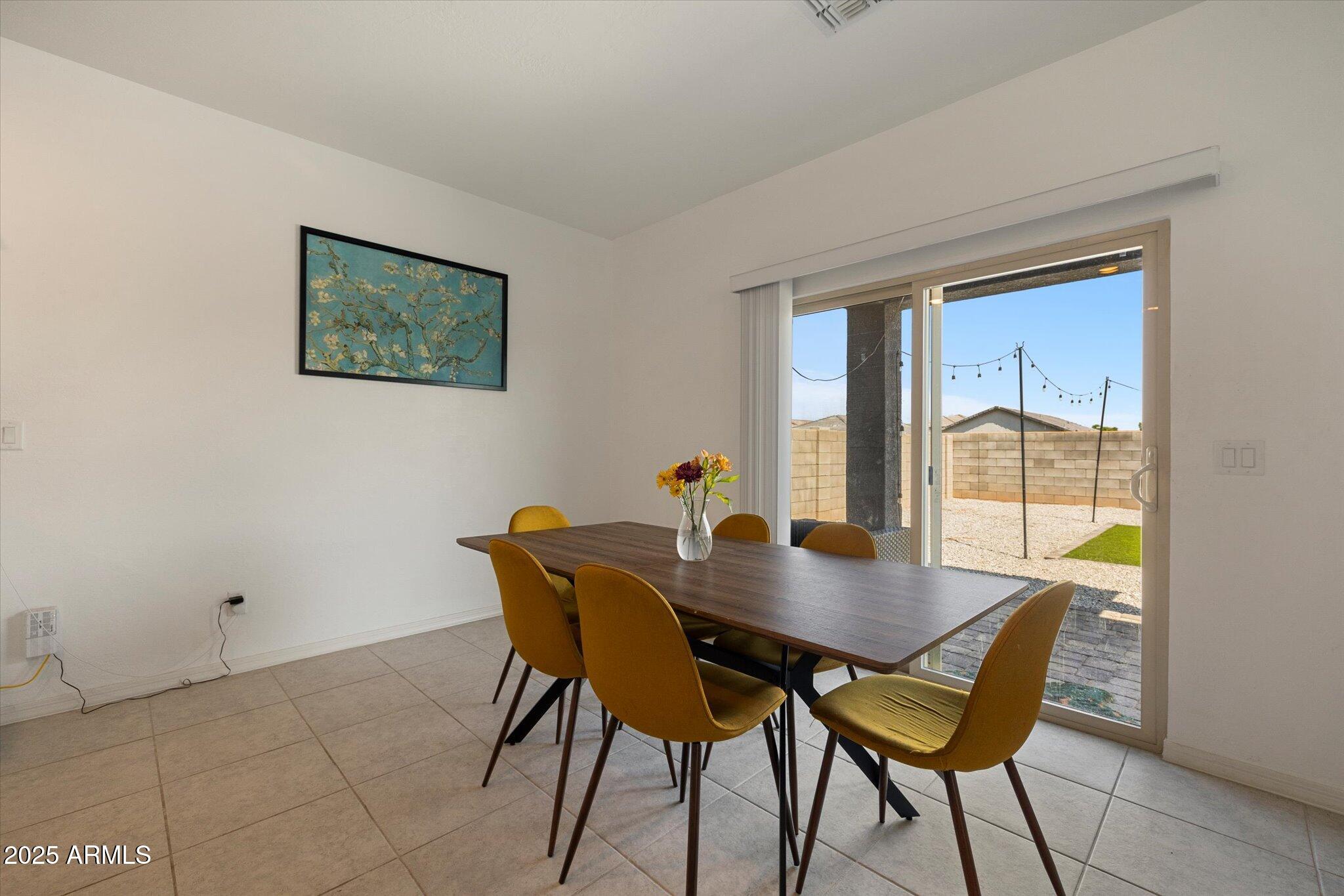 6350 West Latona Road Laveen, AZ 85339 - Photo 10 of 42 a view of a dining room with furniture and window