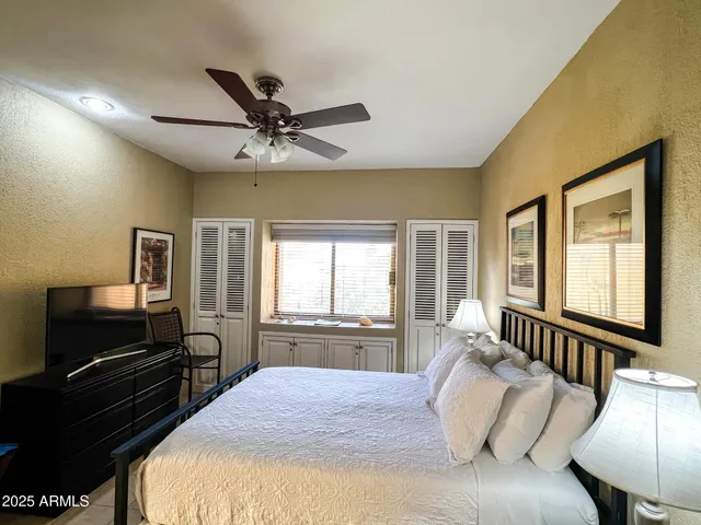 a bedroom with a large bed and a chandelier
