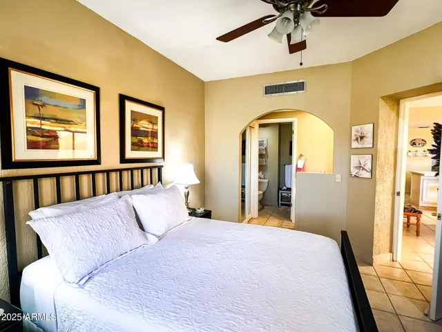 a bed room with a bed and a chandelier