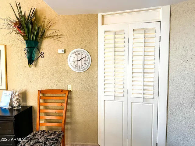 a view of a balcony with chairs and wooden floor