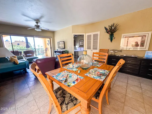 a living room with furniture a fireplace and a floor to ceiling window