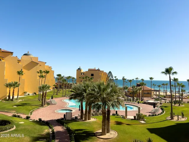 a swimming pool with outdoor seating and yard