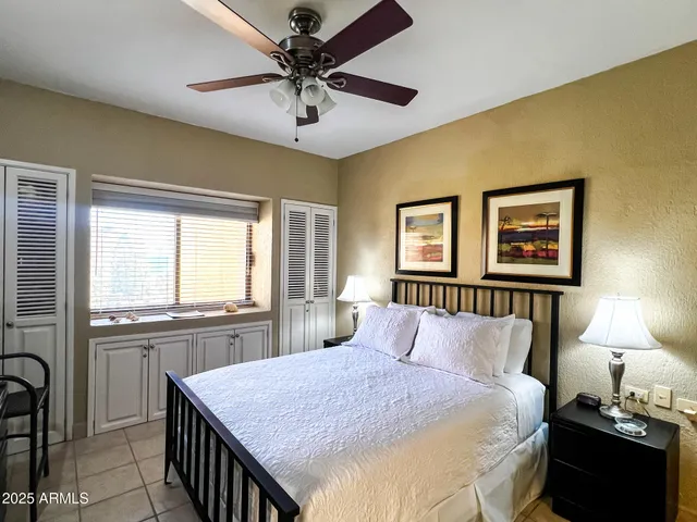 a bedroom with a large bed and a window