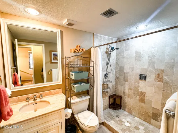 a bathroom with a sink toilet and shower