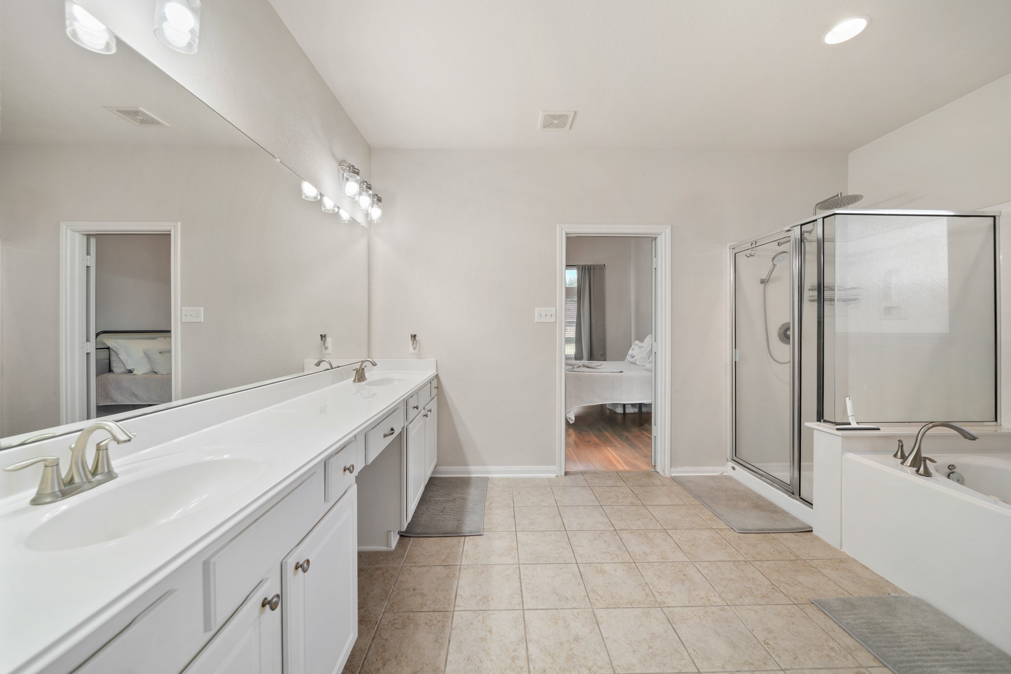 6015 Biltmore Court Rosenberg, TX 77471 - Photo 16 of 31 a bathroom with a double vanity sink and a mirror