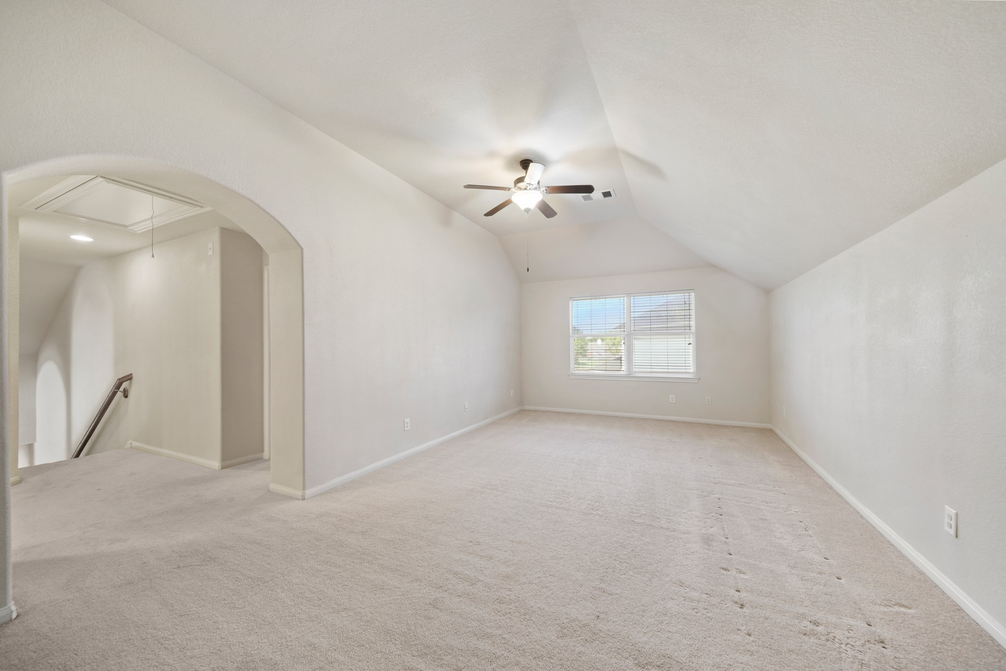 6015 Biltmore Court Rosenberg, TX 77471 - Photo 20 of 31 an empty room with a chandelier fan and windows