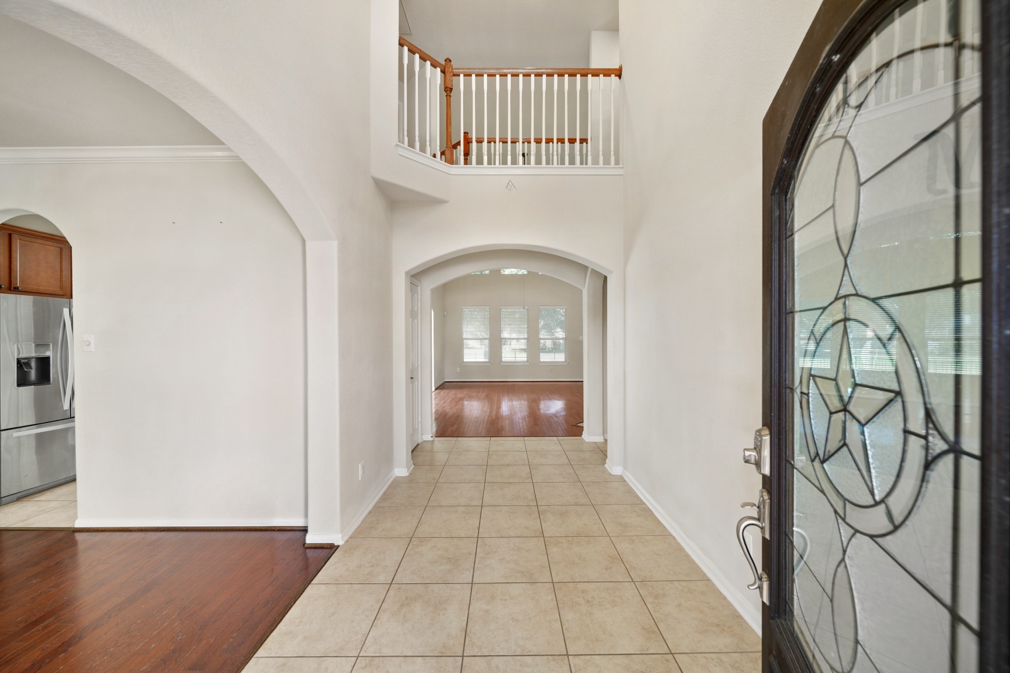 6015 Biltmore Court Rosenberg, TX 77471 - Photo 2 of 31 a view of a hallway with entryway wooden floor and front door