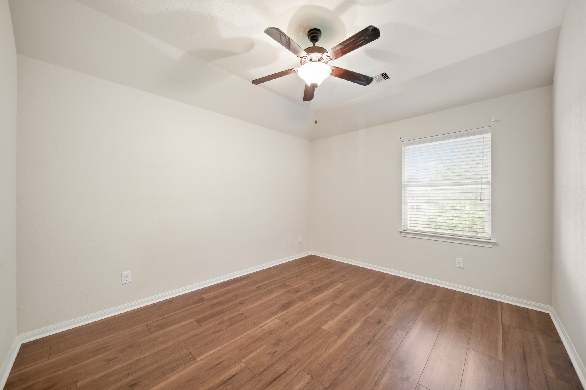 6015 Biltmore Court Rosenberg, TX 77471 - Photo 22 of 31 an empty room with wooden floor and windows