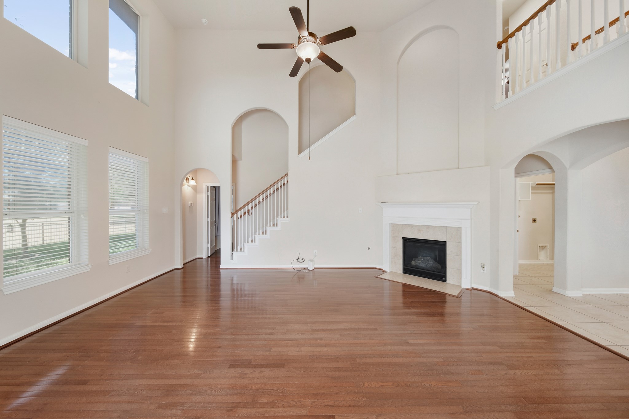 6015 Biltmore Court Rosenberg, TX 77471 - Photo 4 of 31 a view of empty room with fireplace and wooden floor